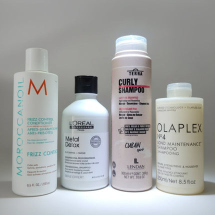 Productos de cuidado capilar organizados sobre un fondo verde con hojas tropicales, representando la campaña Viernes Verde, cambiado por Black Friday